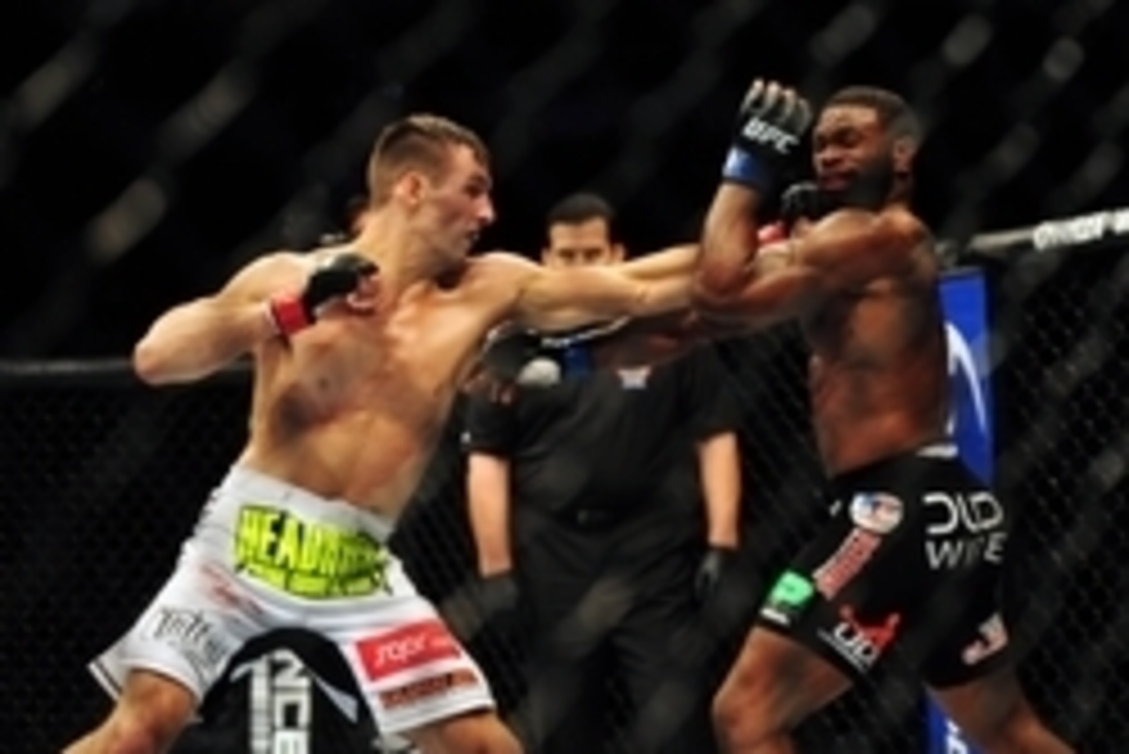 Jun 14, 2014; Vancouver, British Columbia, Canada; Rory MacDonald (red) fights against Tyron Woodley (blue) in their welterweight bout at UFC 174 at Rogers Arena. Mandatory Credit: Anne-Marie Sorvin-USA TODAY Sports