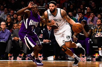 NEW YORK, NY - DECEMBER 29: Deron Williams #8 of the Brooklyn Nets attempts to drive past Darren Collison #7 of the Sacramento Kings in the second half at the Barclays Center on December 29, 2014 in the Brooklyn borough of New York City. NOTE TO USER: Use