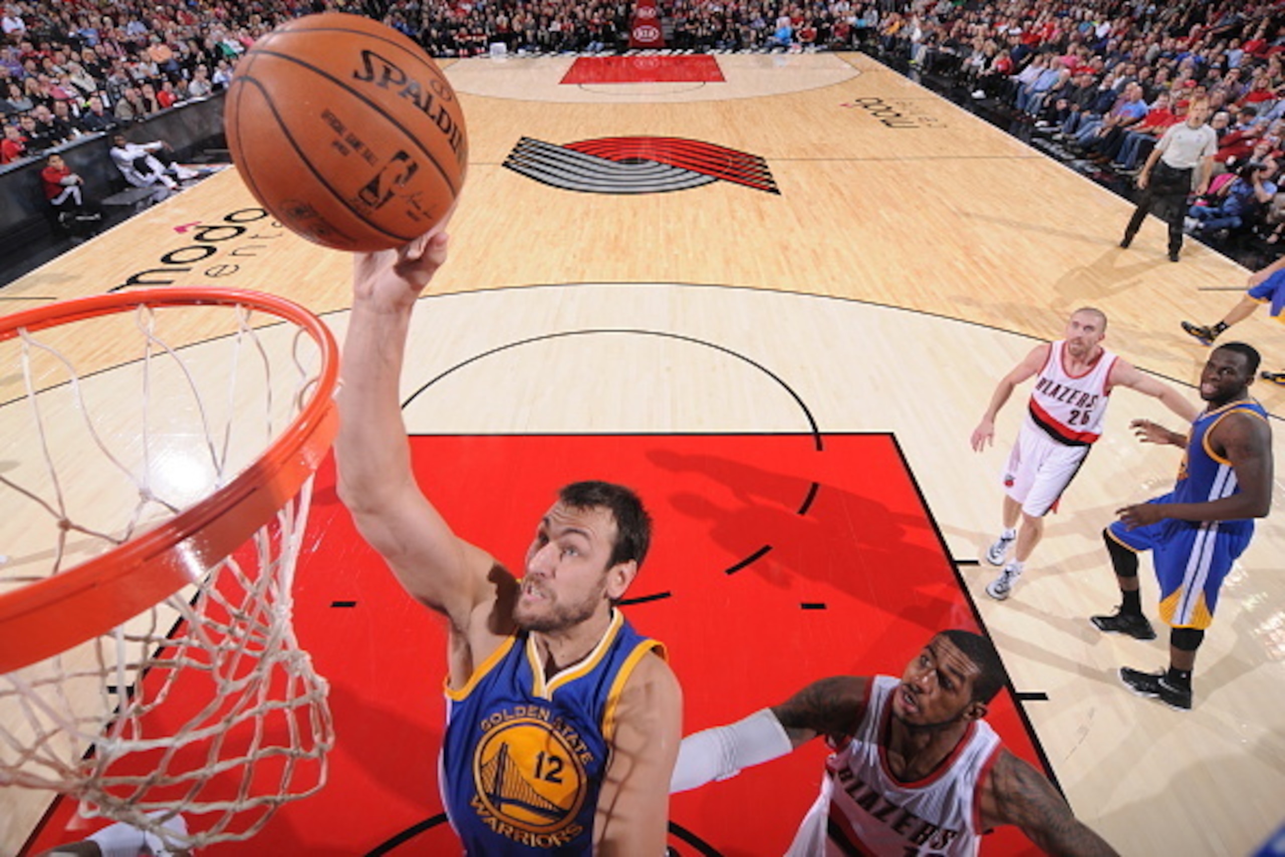 PORTLAND, OR - NOVEMBER 2:  Andrew Bogut #12 of the Golden State Warriors drives to the basket against the Portland Trail Blazers on November 2, 2014 at the Moda Center Arena in Portland, Oregon. NOTE TO USER: User expressly acknowledges and agrees that, 