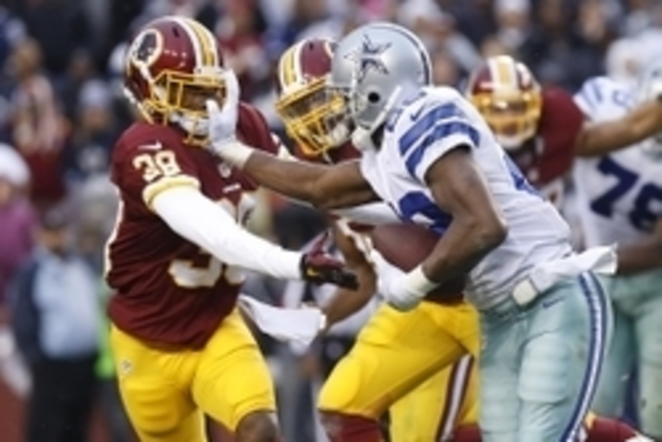Dec 28, 2014; Landover, MD, USA; Dallas Cowboys running back DeMarco Murray (29) carries the ball while stiff-arming Washington Redskins cornerback Justin Rogers (38) in the fourth quarter at FedEx Field. The Cowboys won 44-17. Mandatory Credit: Geoff Bur