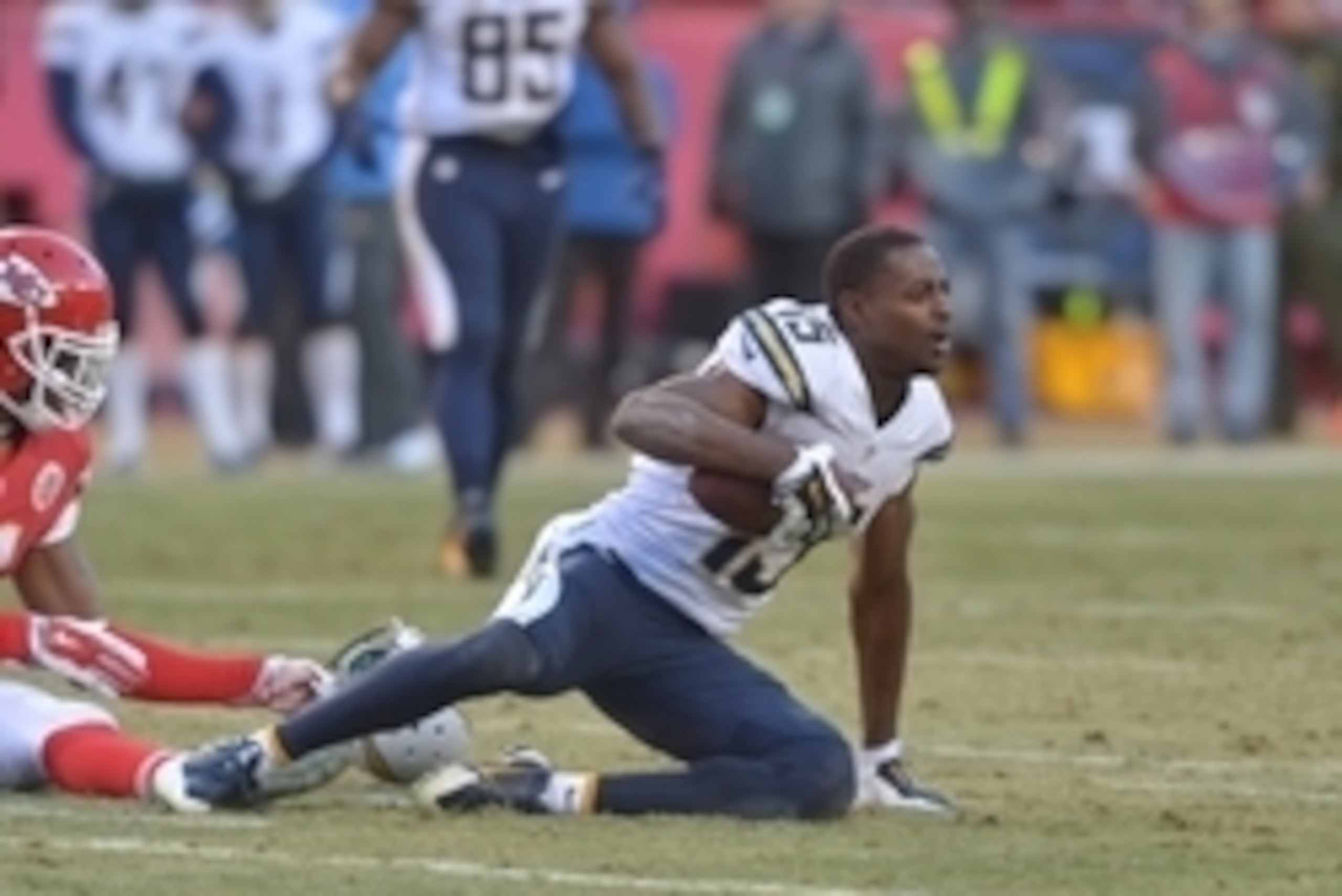 Dec 28, 2014; Kansas City, MO, USA; San Diego Chargers wide receiver Dontrelle Inman (15) looses his helmet after being tackled by Kansas City Chiefs defensive back Jamell Fleming (30) during the second half at Arrowhead Stadium. The Chiefs won 19-7. Mand