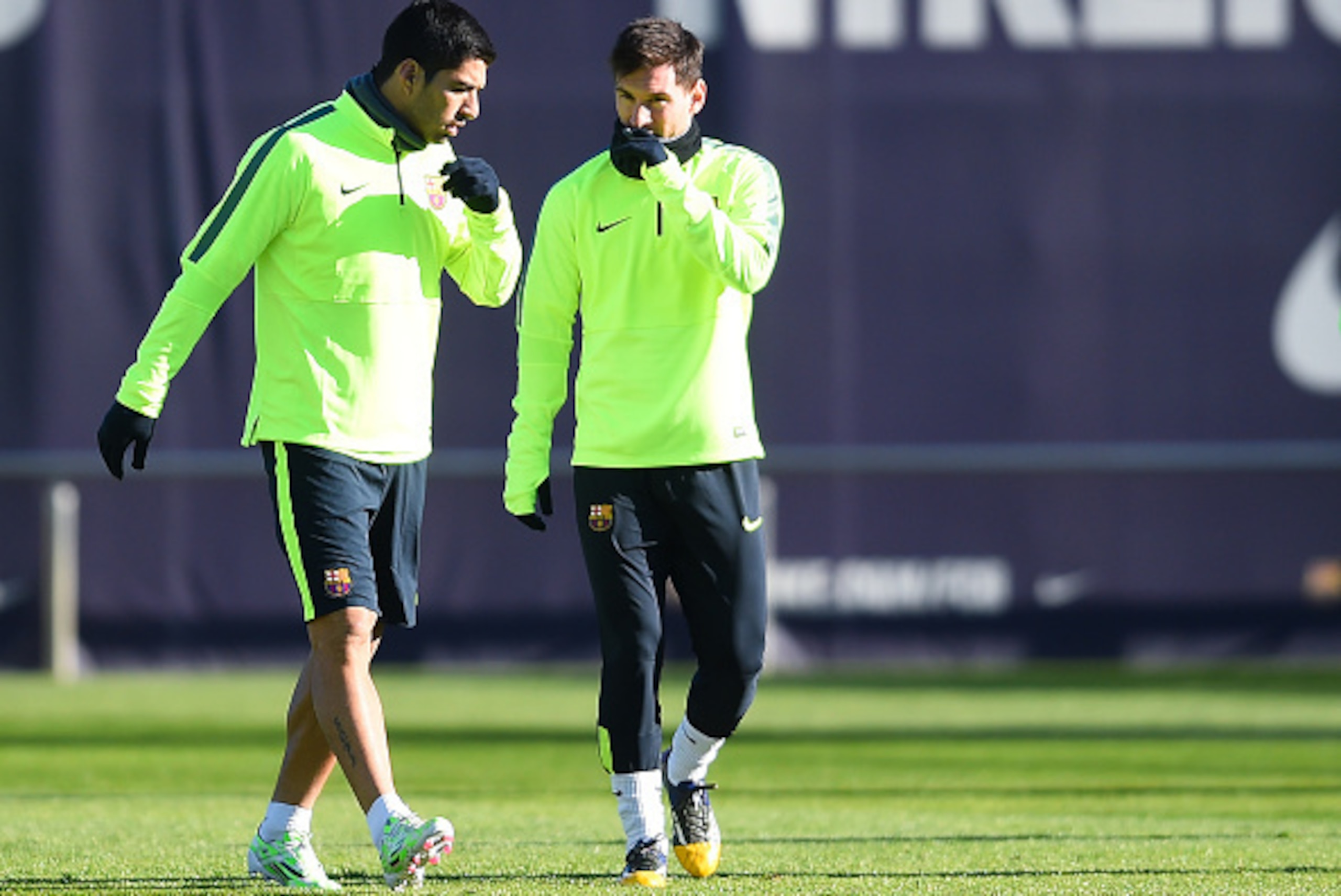 BARCELONA, SPAIN - DECEMBER 09:  Luis Suarez (L) and Lionel Messi of FC Barcelona chats during a training session ahead of their UEFA Champions League Group F match against Paris Saint-Germain FC at Ciutat Esportiva on December 9, 2014 in Barcelona, Spain