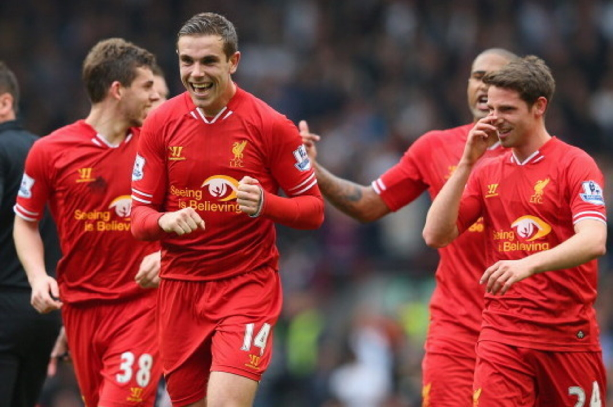 LIVERPOOL, ENGLAND - MARCH 30:  Jordan Henderson of Liverpool celebrates with his team-mates after scoring the fourth goal during the Barclays Premier League match between Liverpool and Tottenham Hotspur at Anfield on March 30, 2014 in Liverpool, England.