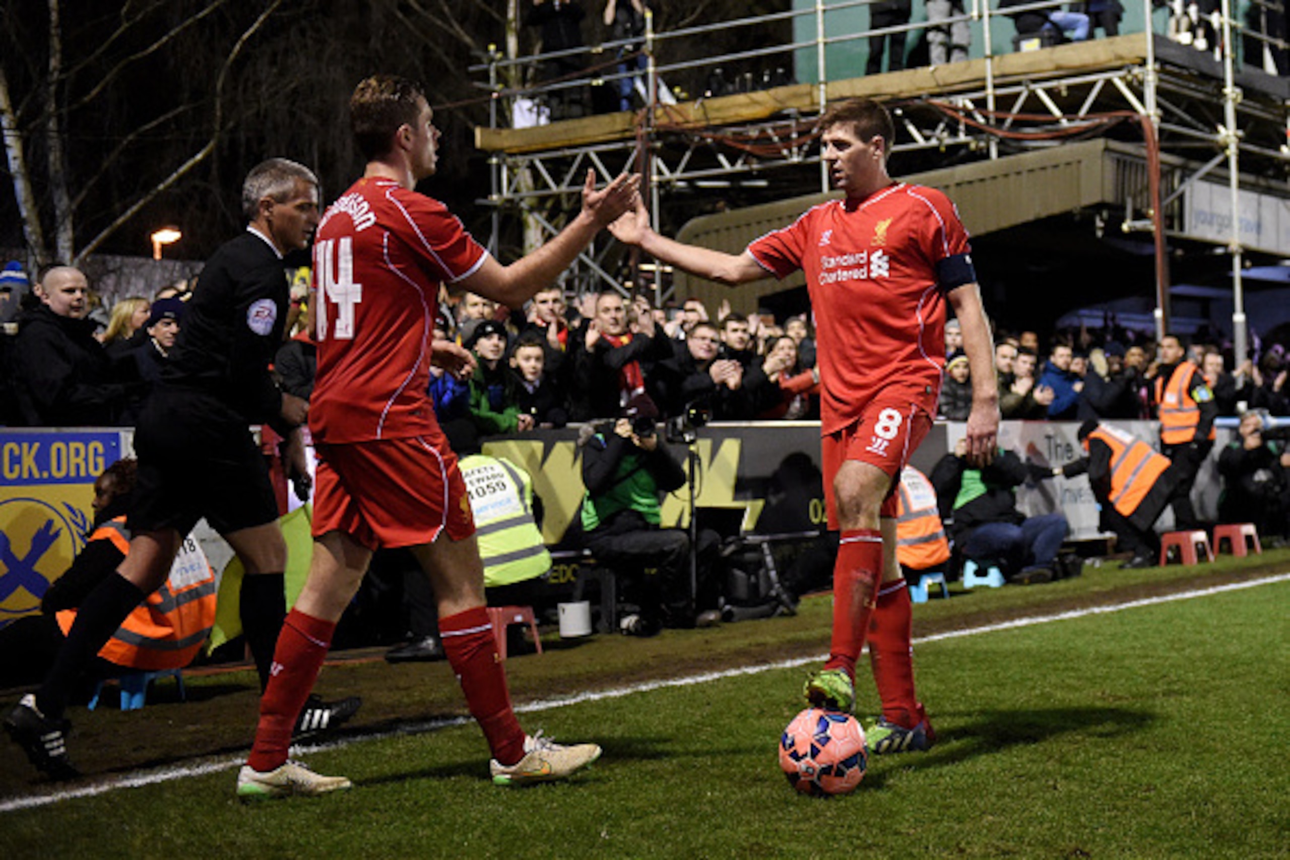 KINGSTON UPON THAMES, ENGLAND - JANUARY 05:  Liverpool teammates Jordan Henderson and Steven Gerrard shake hands following their team's 2-1 victory during the FA Cup Third Round match between AFC Wimbledon and Liverpool at The Cherry Red Records Stadium o