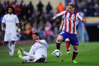 MADRID, SPAIN - JANUARY 07:  Fernando Torres of Club Atletico de Madrid gets past Sergio Ramos of Real Madrid
during the Copa del Rey Round of 16, First Leg match between Club Atletico de Madrid and Real Madrid at Vicente Calderon Stadium on January 7, 20
