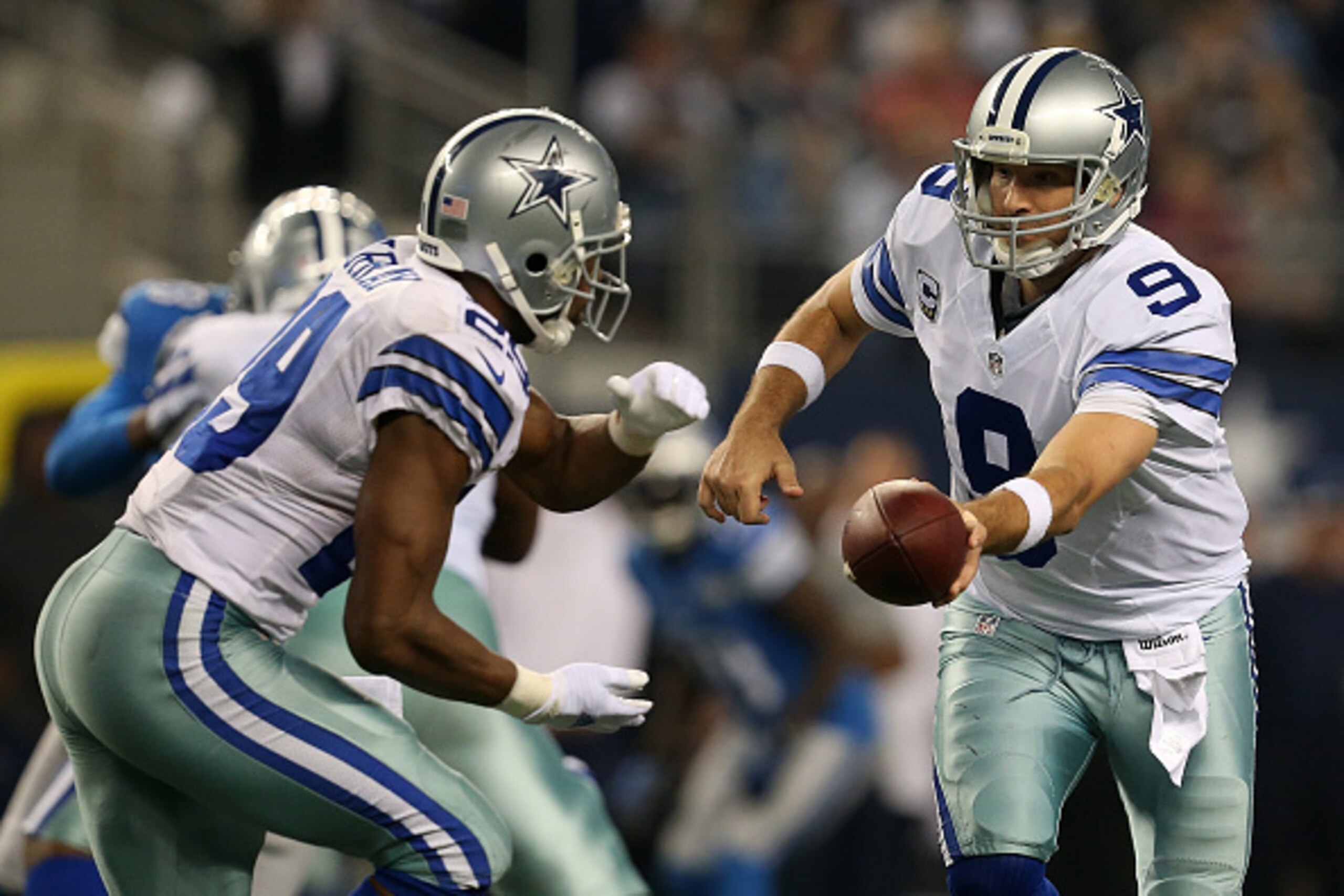 ARLINGTON, TX - JANUARY 04: Tony Romo #9 hands off to DeMarco Murray #29 of the Dallas Cowboys during a NFC Wild Card Playoff game against the Detroit Lions at AT&T Stadium on January 4, 2015 in Arlington, Texas.  (Photo by Sarah Glenn/Getty Images)