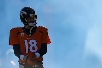 DENVER, CO - DECEMBER 28:  Quarterback Peyton Manning #18 of the Denver Broncos emerges from the tunnel during player introductions before a game against the Oakland Raiders at Sports Authority Field at Mile High on December 28, 2014 in Denver, Colorado. 
