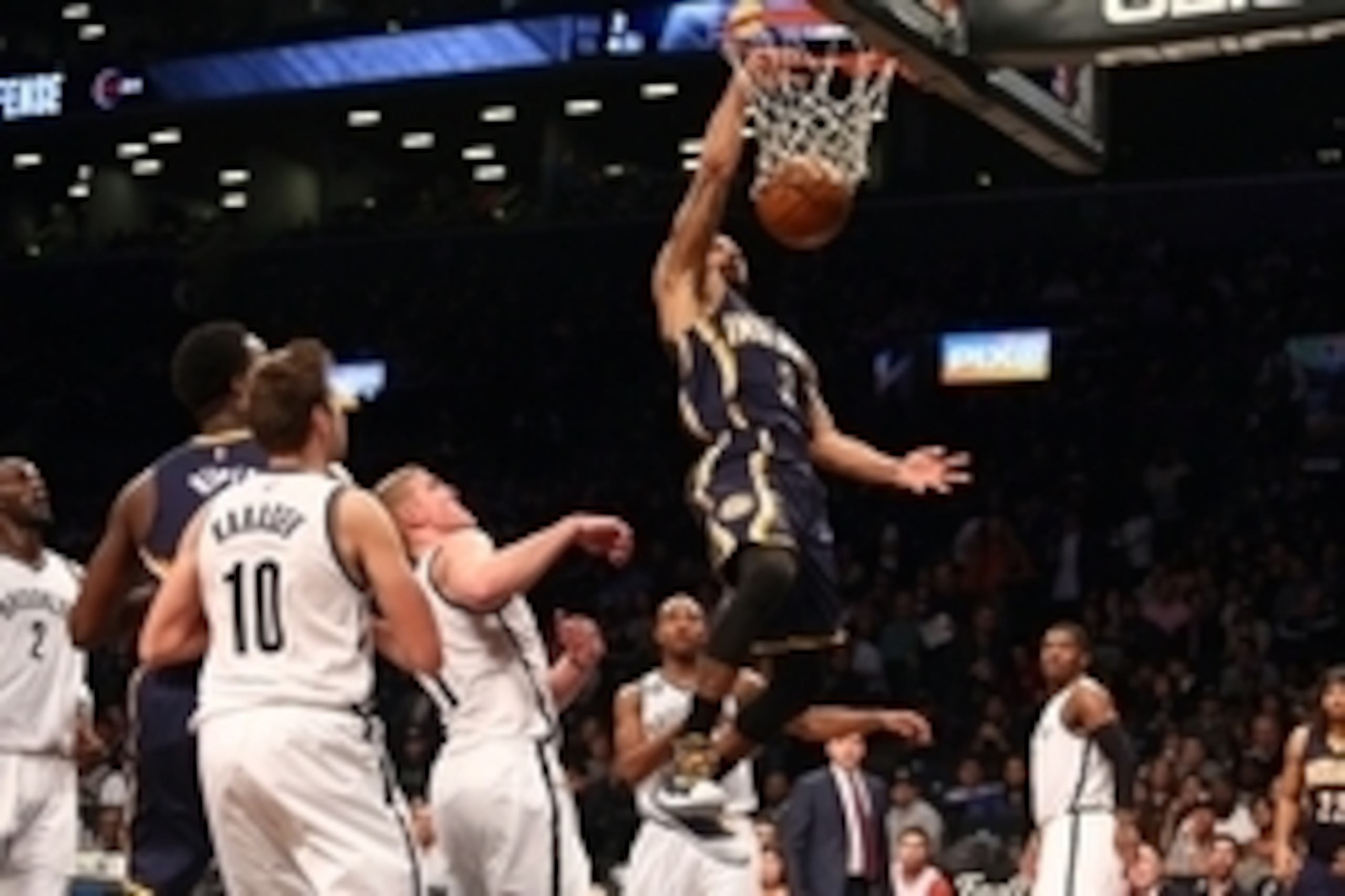 Dec 27, 2014; Brooklyn, NY, USA; Indiana Pacers point guard George Hill (3) dunks over Brooklyn Nets center Mason Plumlee (1) and Brooklyn Nets shooting guard Sergey Karasev (10) during the third quarter at Barclays Center. The Pacers defeated the Nets 11