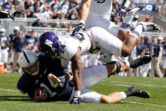 STATE COLLEGE, PA - SEPTEMBER 27:  Ibraheim Campbell #24 of the Northwestern Wildcats tackles Christian Hackenberg #14 of the Penn State Nittany Lions in the first half during the game on September 27, 2014 at Beaver Stadium in State College, Pennsylvania