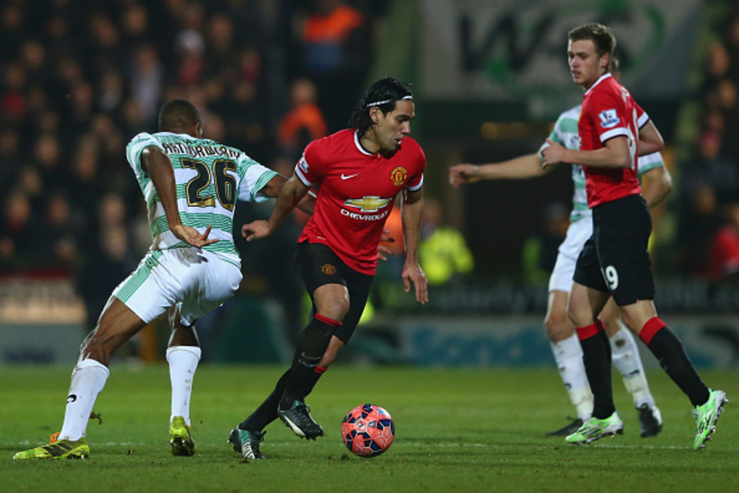 YEOVIL, ENGLAND - JANUARY 04:  Radamel Falcao of Manchester United is tracked by Stephen Arthurworrey of Yeovil Town during the FA Cup Third Round match between Yeovil Town and Manchester United at Huish Park on January 4, 2015 in Yeovil, England.  (Photo