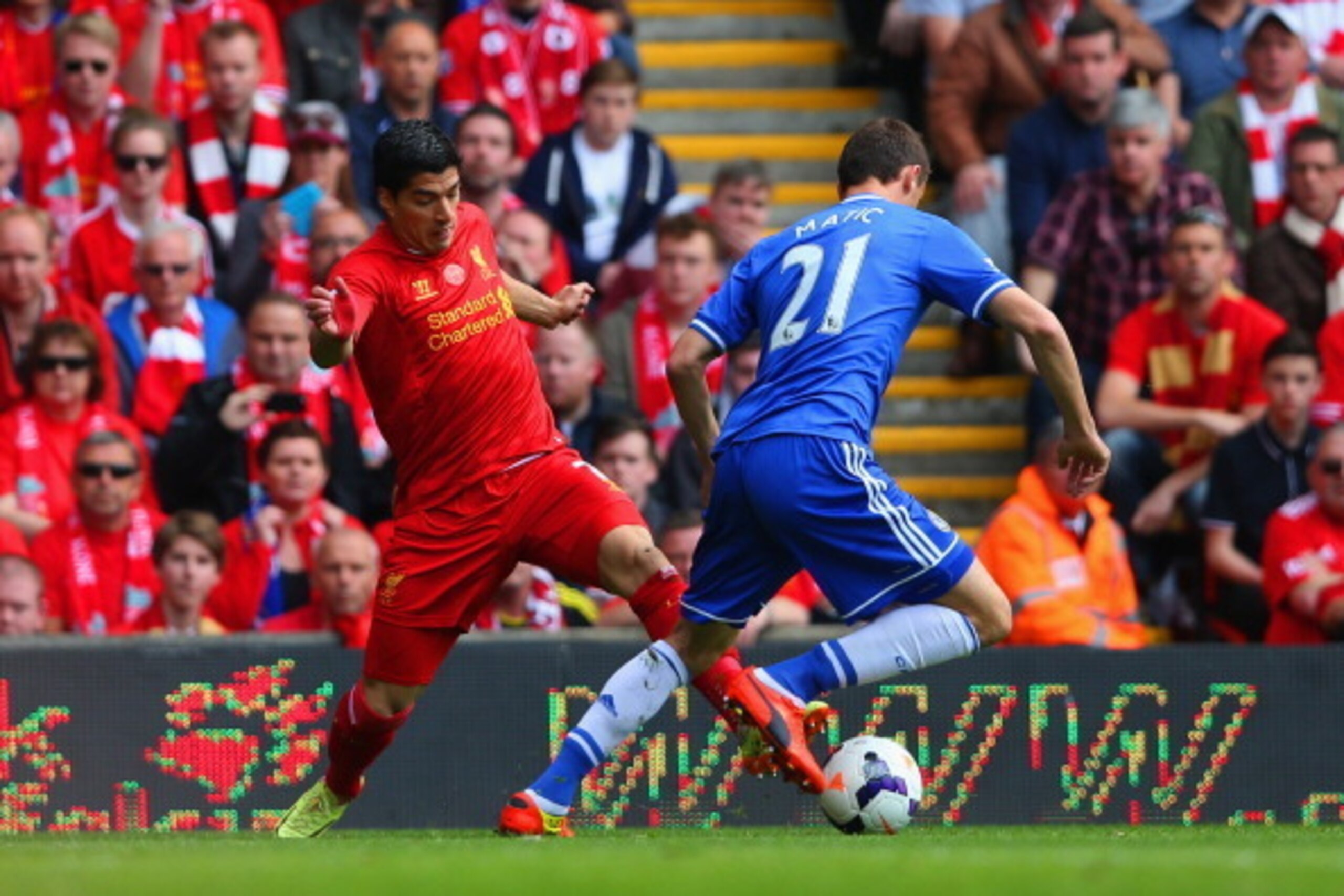 LIVERPOOL, ENGLAND - APRIL 27:  Luis Suarez of Liverpool is tackled by Nemanja Matic of Chelsea during the Barclays Premier League match between Liverpool and Chelsea at Anfield on April 27, 2014 in Liverpool, England.  (Photo by Clive Brunskill/Getty Ima