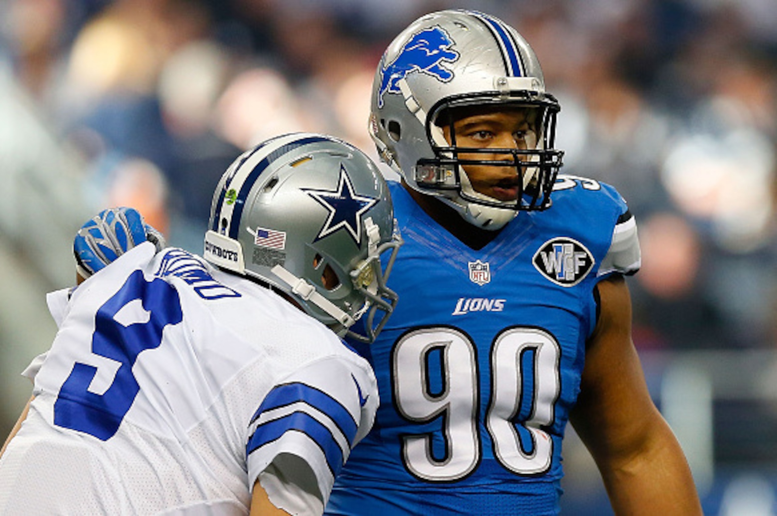 ARLINGTON, TX - JANUARY 04: Ndamukong Suh #90 of the Detroit Lions helps Tony Romo #9 of the Dallas Cowboys to his feet during the first half of their NFC Wild Card Playoff game at AT&T Stadium on January 4, 2015 in Arlington, Texas. (Photo by Tom Penn ARLINGTON, TX - JANUARY 04: Ndamukong Suh #90 of the Detroit Lions helps Tony Romo #9 of the Dallas Cowboys to his feet during the first half of their NFC Wild Card Playoff game at AT&T Stadium on January 4, 2015 in Arlington, Texas. (Photo by Tom Penn