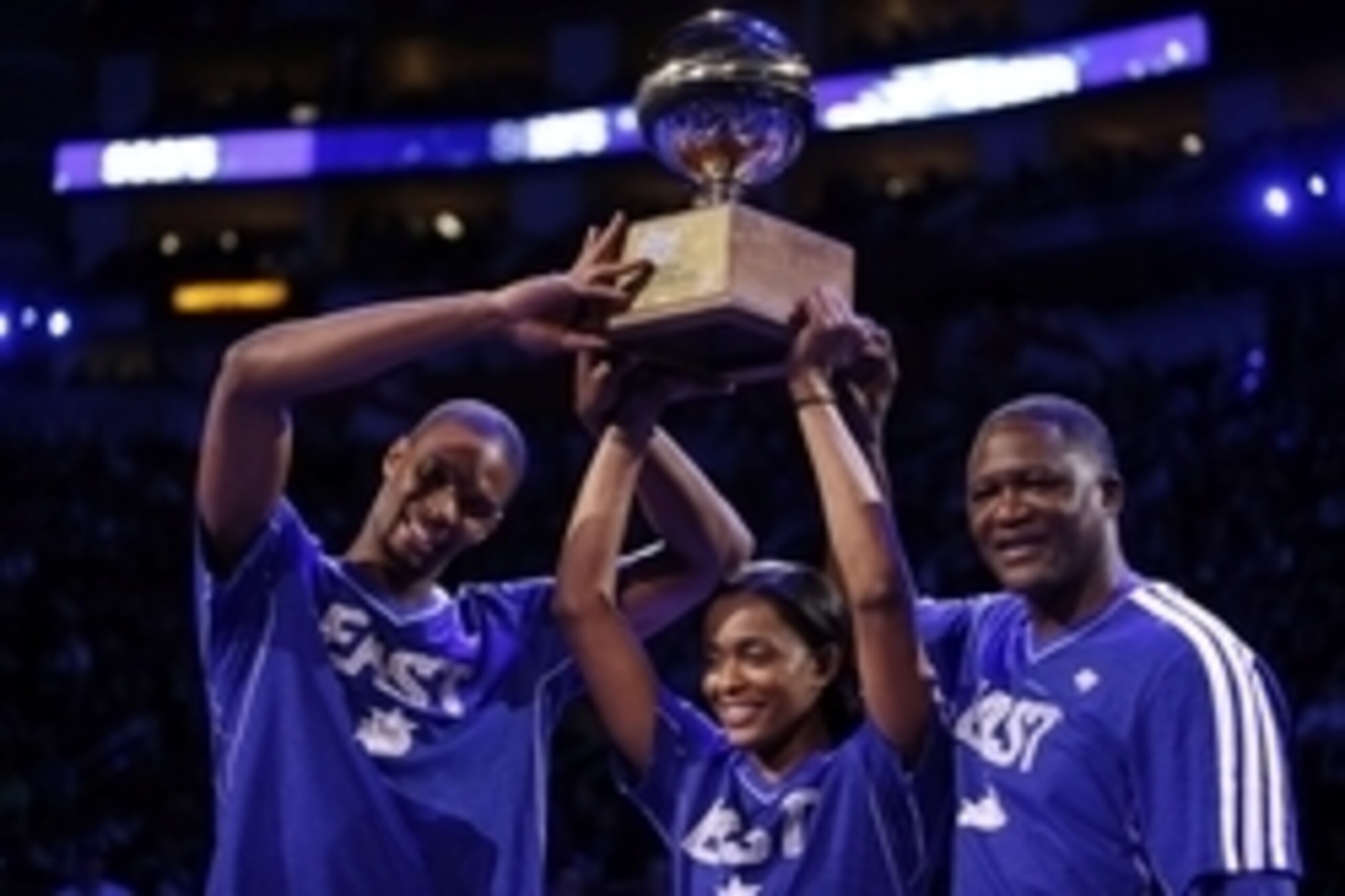Feb 16, 2013; Houston, TX, USA; Miami Heat player Chris Bosh (left) hoists the shooting stars trophy with Chicago Sky player Swin Cash (middle) and Atlanta Hawks former player Dominique Wilkins (right) after the 2013 NBA all star shooting stars competitio