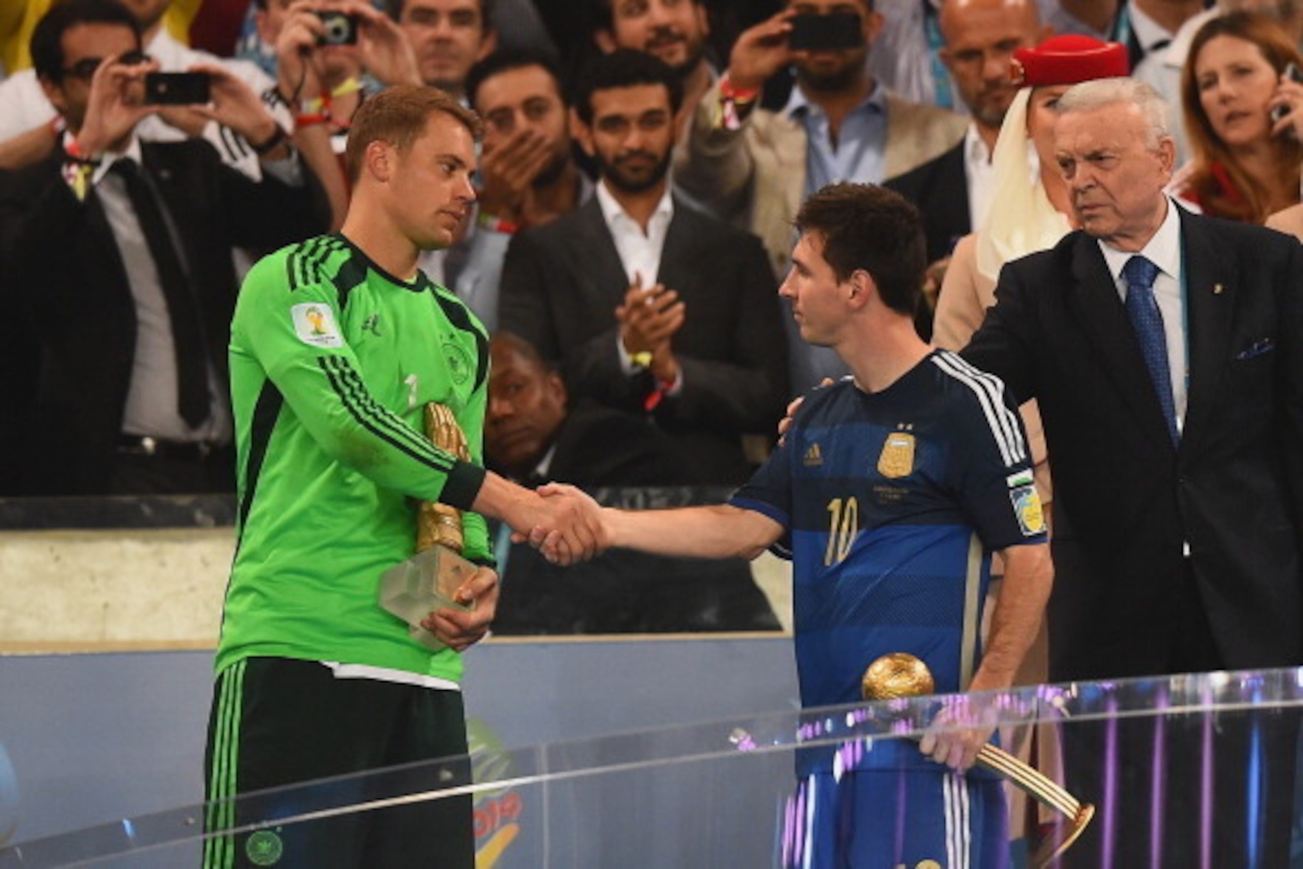 RIO DE JANEIRO, BRAZIL - JULY 13: Golden Glove winner Manuel Neuer of Germany shakes hands with Golden Ball winner Lionel Messi of Argentina after Germany's 1-0 win in extra time during the 2014 FIFA World Cup Brazil Final match between Germany and Argen RIO DE JANEIRO, BRAZIL - JULY 13: Golden Glove winner Manuel Neuer of Germany shakes hands with Golden Ball winner Lionel Messi of Argentina after Germany's 1-0 win in extra time during the 2014 FIFA World Cup Brazil Final match between Germany and Argen