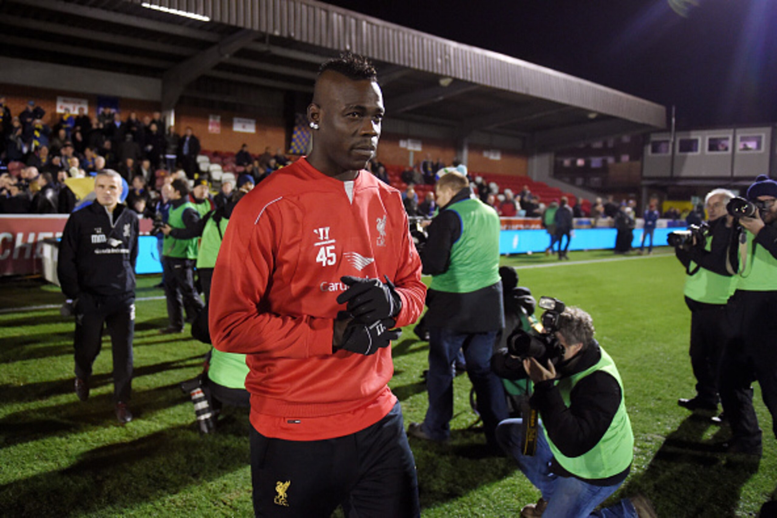 KINGSTON UPON THAMES, ENGLAND - JANUARY 05:  Mario Balotelli of Liverpool walks out onto the pitch for the warm up prior to kickoff during the FA Cup Third Round match between AFC Wimbledon and Liverpool at The Cherry Red Records Stadium on January 5, 201