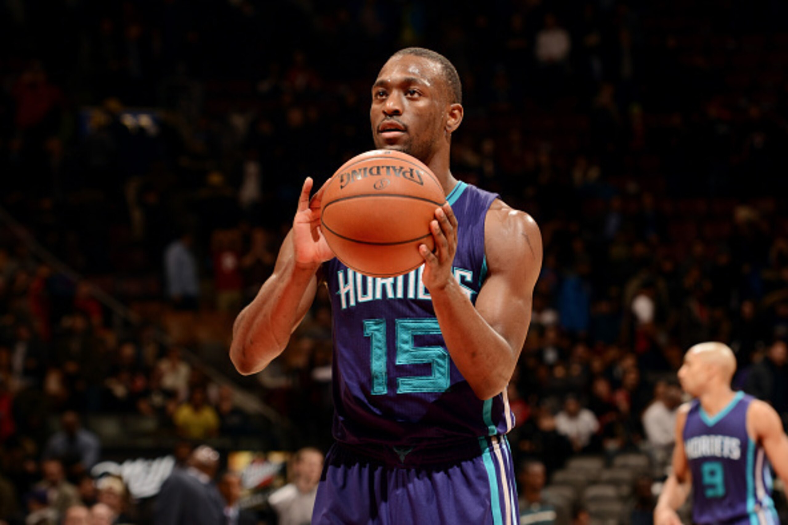 TORONTO, CANADA - January 8: Kemba Walker #15 of the Charlotte Hornets attempts a free throw against the Toronto Raptors on January 8, 2015 at the Air Canada Centre in Toronto, Ontario, Canada.  NOTE TO USER: User expressly acknowledges and agrees that, b