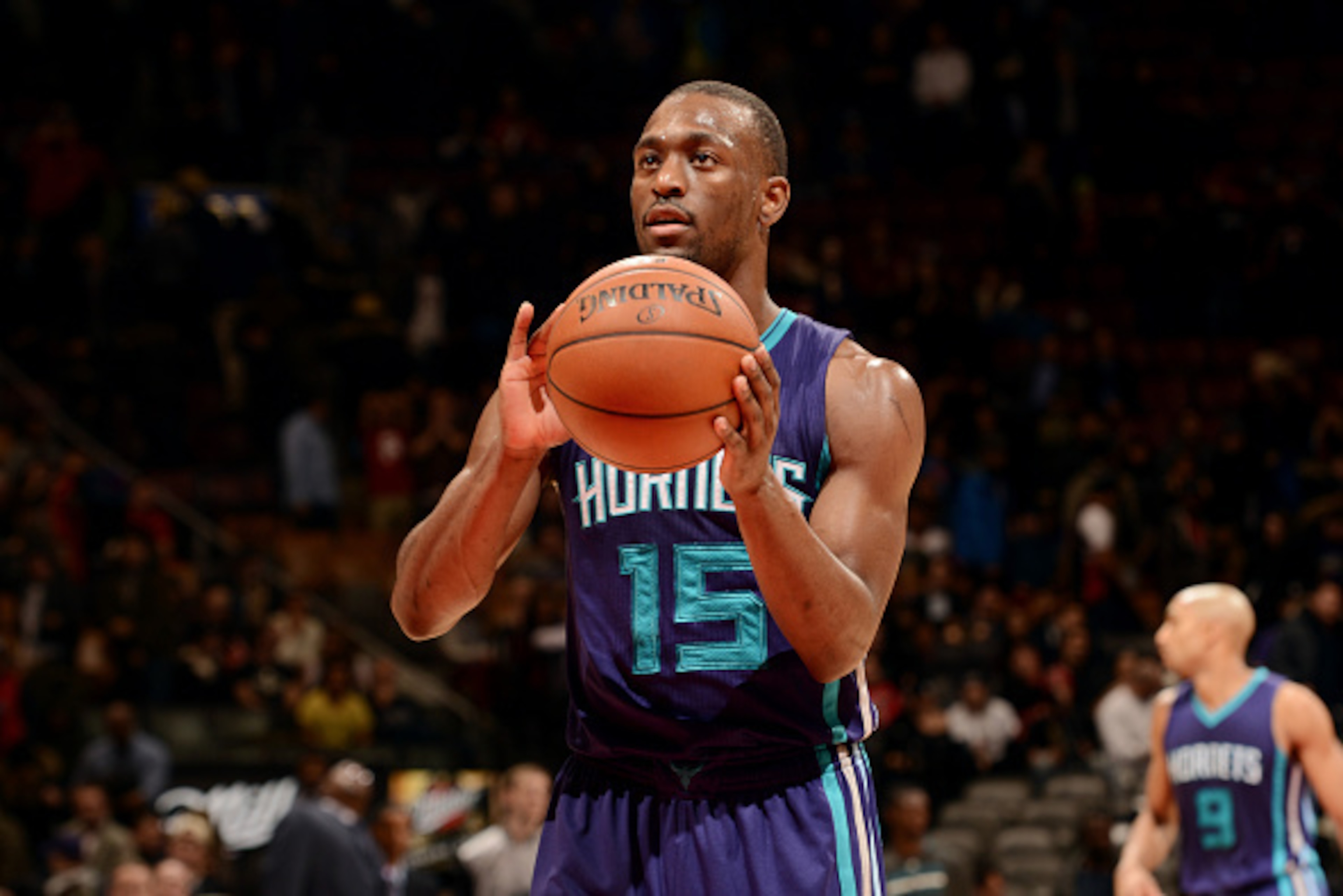 TORONTO, CANADA - January 8: Kemba Walker #15 of the Charlotte Hornets attempts a free throw against the Toronto Raptors on January 8, 2015 at the Air Canada Centre in Toronto, Ontario, Canada.  NOTE TO USER: User expressly acknowledges and agrees that, b