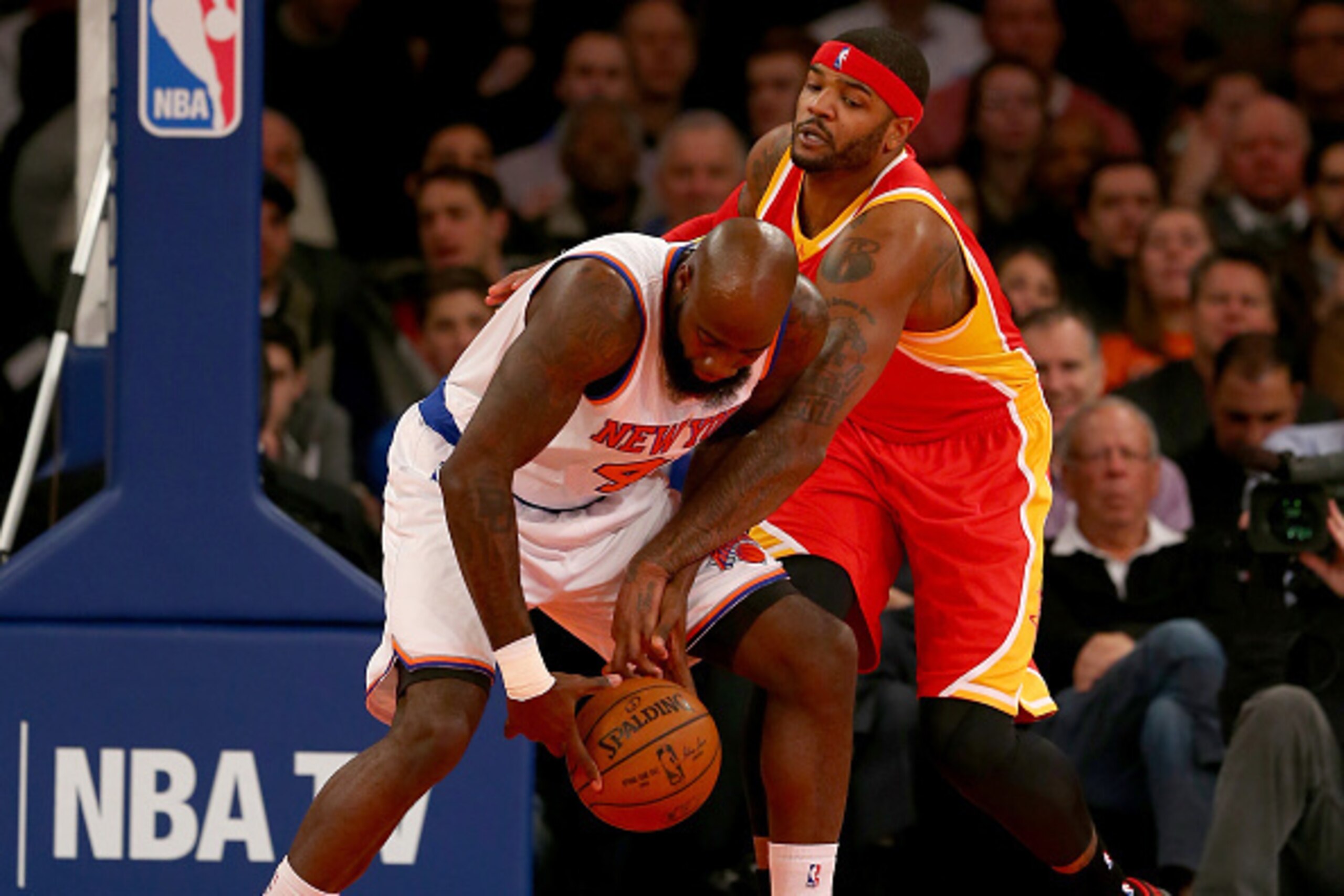 NEW YORK, NY - JANUARY 08:  Josh Smith #5 of the Houston Rockets fouls Quincy Acy #4 of the New York Knicks in the first quarter at Madison Square Garden on January 8, 2015 in New York City. NOTE TO USER: User expressly acknowledges and agrees that, by do