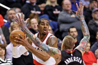 Jan 8, 2015; Portland, OR, USA; Portland Trail Blazers forward LaMarcus Aldridge (12) looks to pass around Miami Heat forward Chris Andersen (11) during the third quarter at the Moda Center. Mandatory Credit: Craig Mitchelldyer-USA TODAY Sports