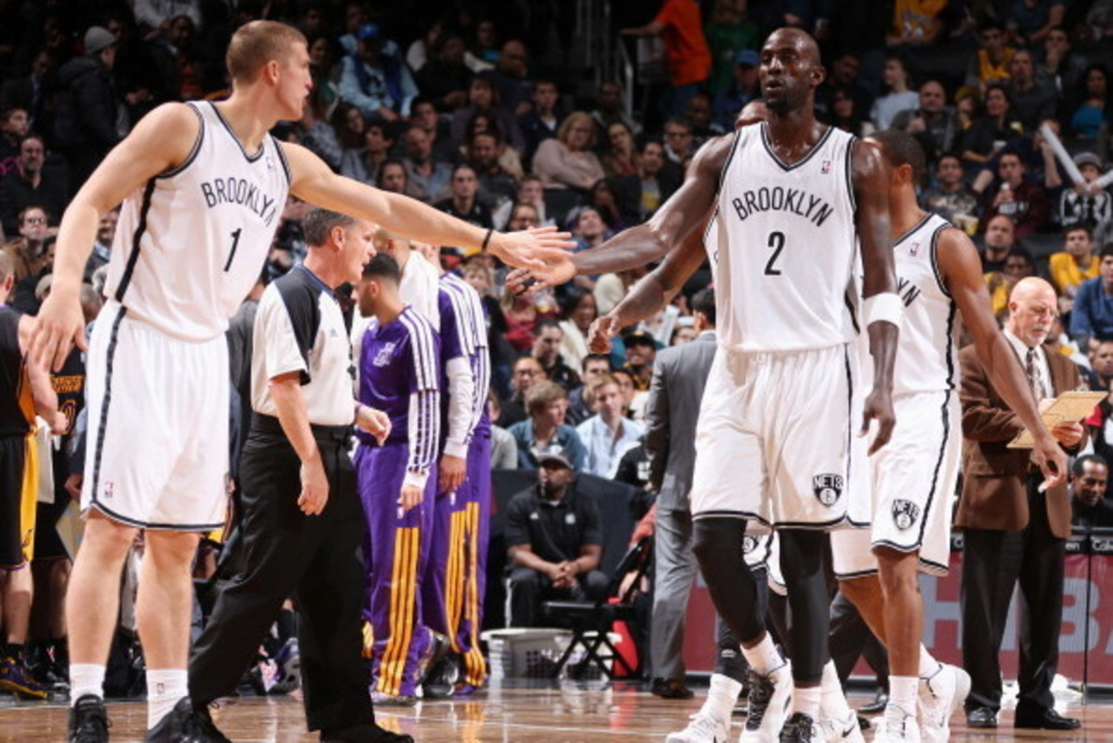 NEW YORK, NY - NOVEMBER 27: Teammates Mason Plumlee #1 of the Brooklyn Nets and Kevin Garnett #2 of the Brooklyn Nets high five during a game against the Los Angeles Lakers at Barclays Center on November 27, 2013 in the Brooklyn borough of New York City. 