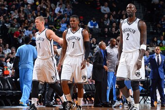 BROOKLYN,NY - DECEMBER 23: Mason Plumlee #1, Joe Johnson #7 and Kevin Garnett #2 of the Brooklyn Nets look on against the Denver Nuggets on December 23, 2014 at the Barclays Center in Brooklyn, NY. NOTE TO USER: User expressly acknowledges and agrees that