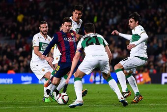 BARCELONA, SPAIN - JANUARY 08:  Lionel Messi of FC Barcelona competes for the ball among Elche FC players during the Copa del Rey  Round of 16 First Leg match between FC Barcelona and Elche CF at Camp Nou on January 8, 2015 in Barcelona, Spain.  (Photo by