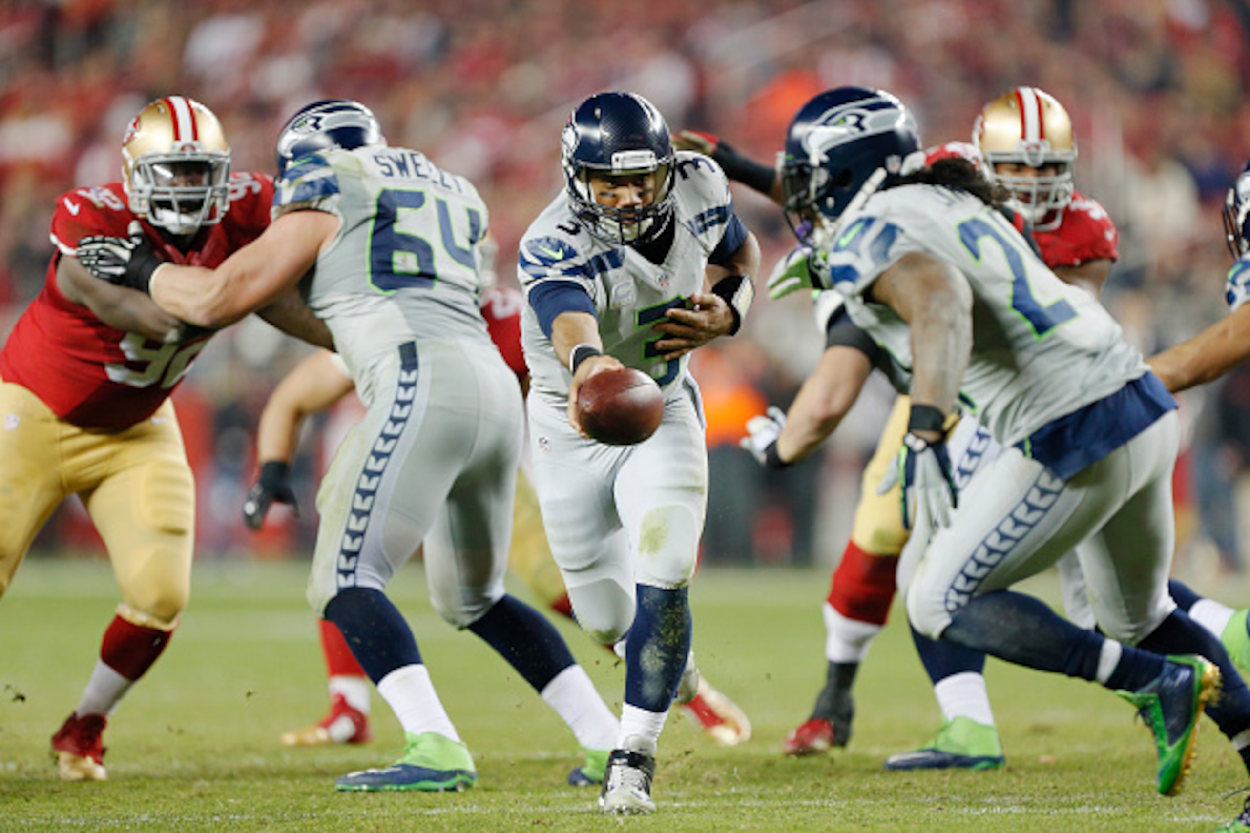 SANTA CLARA, CA - NOVEMBER 27:  Quarterback Russell Wilson #3 of the Seattle Seahawks hands the ball off to Marshawn Lynch #24 against the San Francisco 49ers in the third quarter on November 27, 2014 at Levi's Stadium in Santa Clara, California.  The Sea