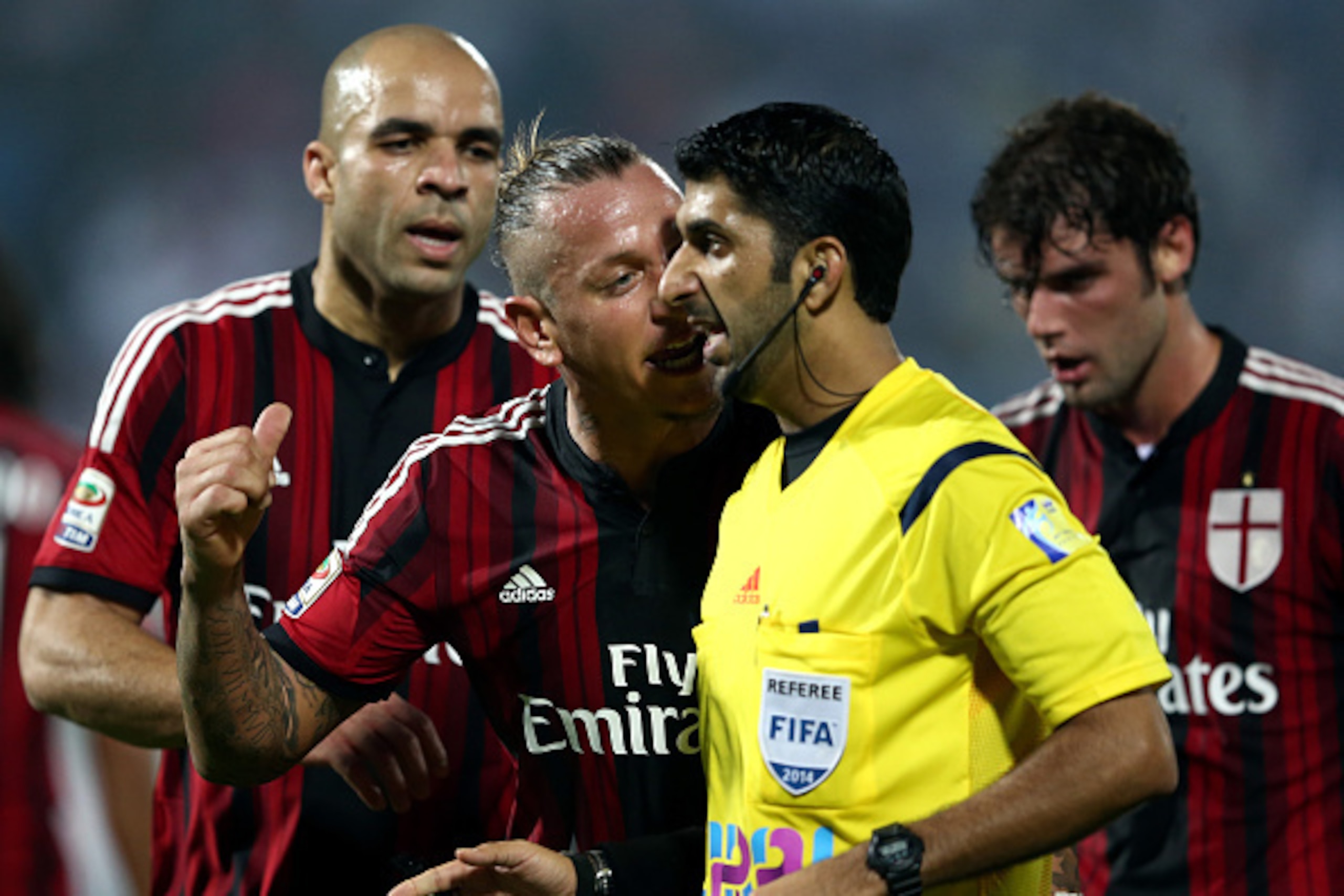 DUBAI, UNITED ARAB EMIRATES - DECEMBER 30:  Phillippe Mexes of AC Milan argues with referee Mohammed Abdulla Hassan Mohammed as he recieves a yellow card during the Dubai Football Challenge match between AC Milan and Real Madrid at The Sevens Stadium on D