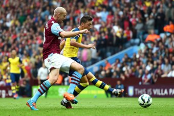 BIRMINGHAM, ENGLAND - SEPTEMBER 20:  Mesut Oezil of Arsenal scores the opening goal during the Barclays Premier League match between Aston Villa and Arsenal at Villa Park on September 20, 2014 in Birmingham, England.  (Photo by Laurence Griffiths/Getty Im