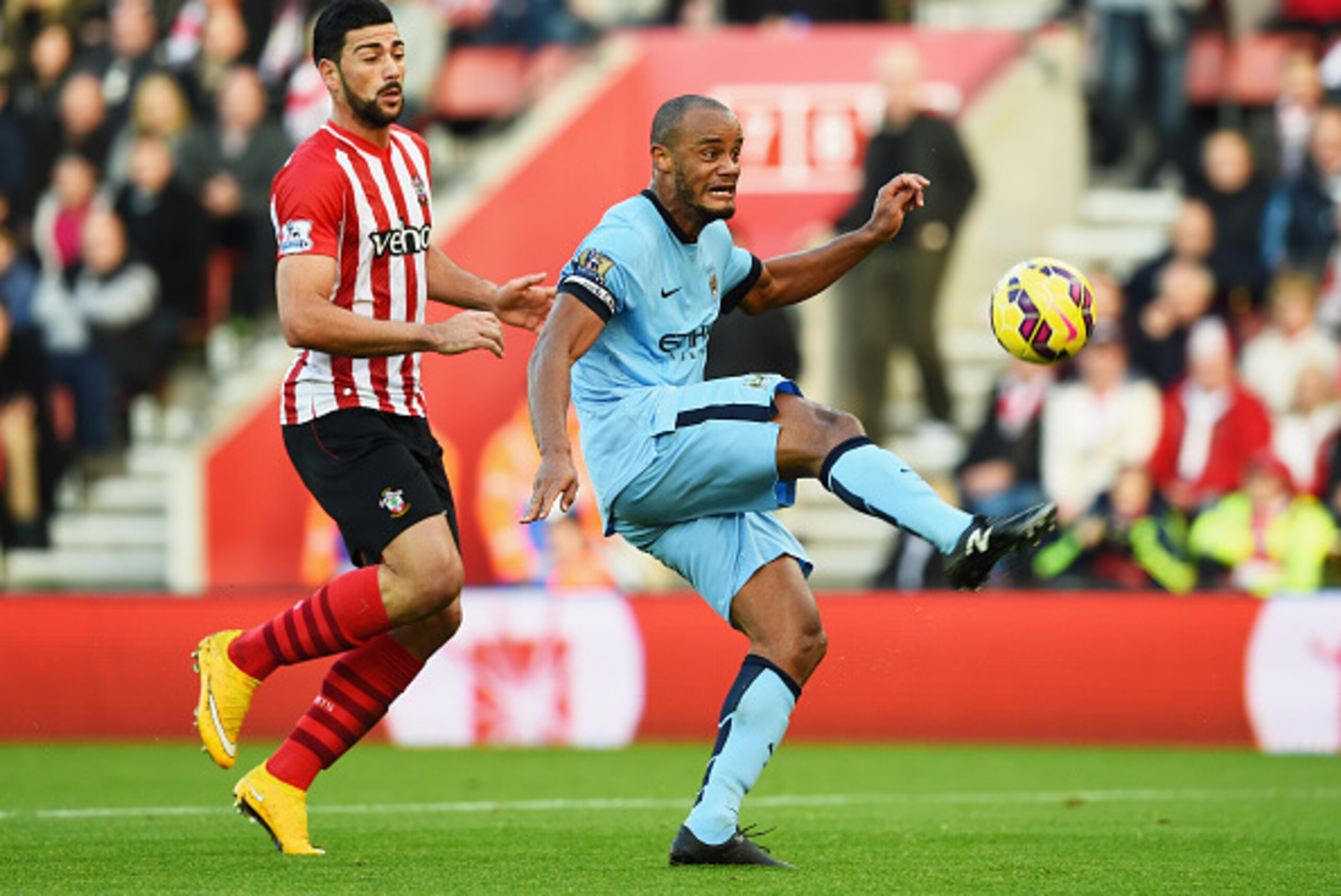 SOUTHAMPTON, ENGLAND - NOVEMBER 30:  Vincent Kompany of Manchester City clears the ball from Graziano Pelle of Southampton during the Barclays Premier League match between Southampton and Manchester City at St Mary's Stadium on November 30, 2014 in Southa