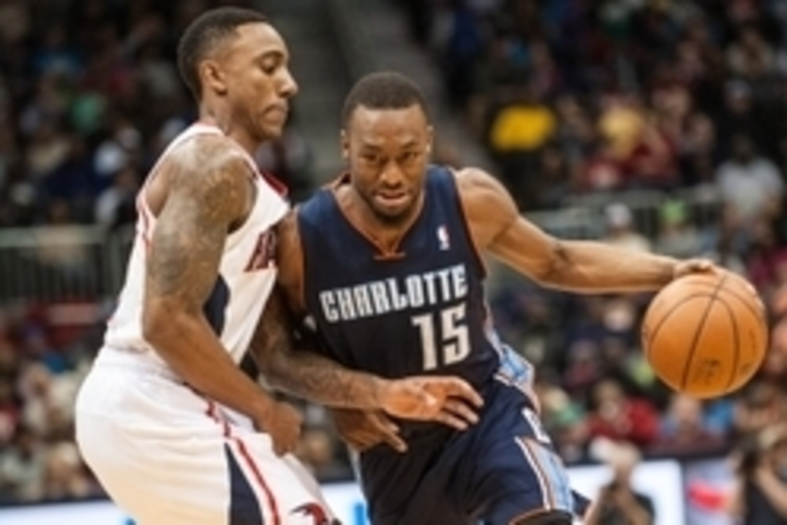 Dec 28, 2013; Atlanta, GA, USA; Atlanta Hawks point guard Jeff Teague (0) defends Charlotte Bobcats point guard Kemba Walker (15) during the second quarter at Philips Arena. Mandatory Credit: Kevin Liles-USA TODAY Sports