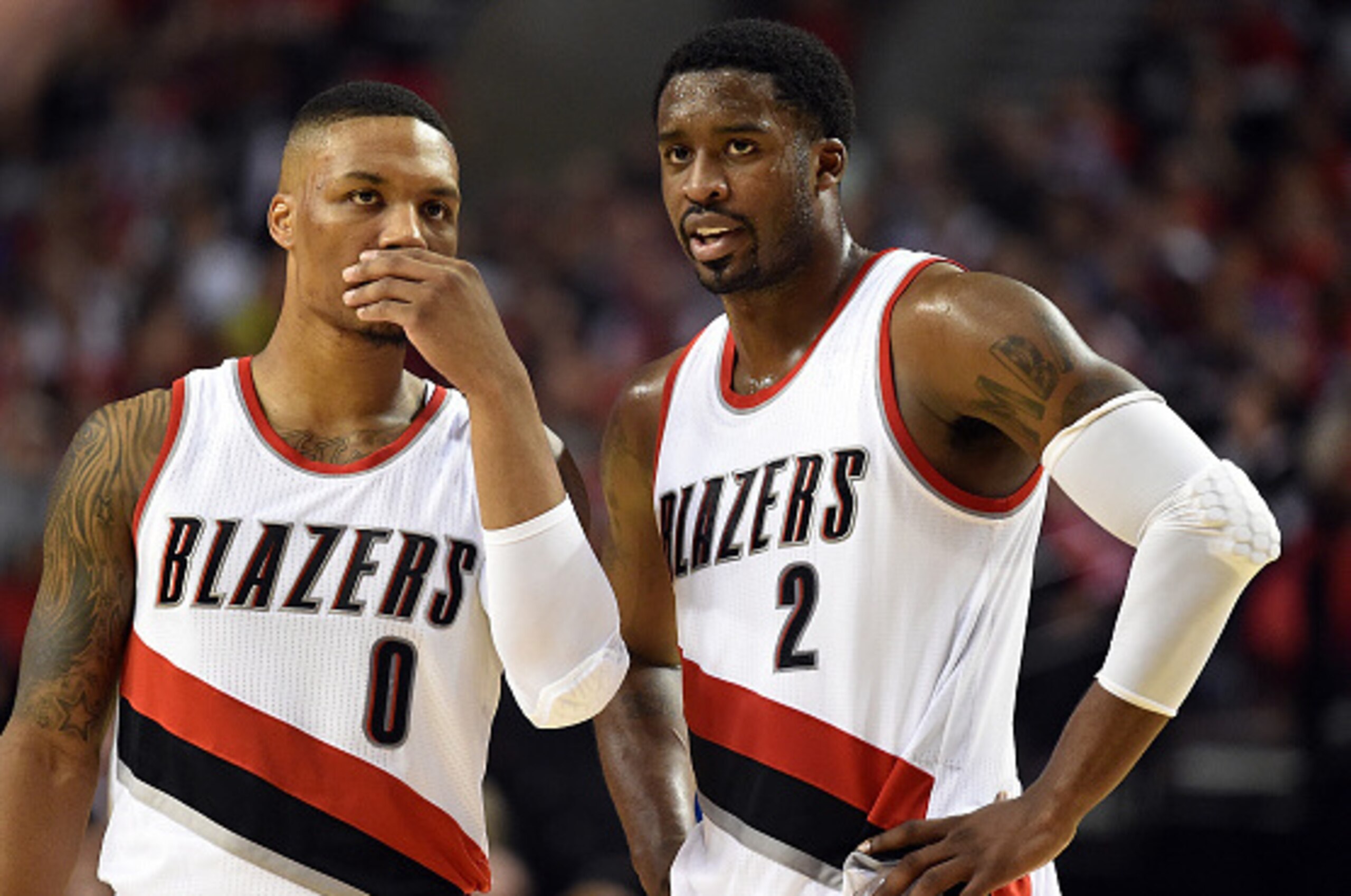 PORTLAND, OR - OCTOBER 29: Damian Lillard #0 and Wesley Matthews #2 of the Portland Trail Blazers chat in the third quarter of the game against the Oklahoma City Thunder at Moda Center on October 29, 2014 in Portland, Oregon.  NOTE TO USER: User expressly