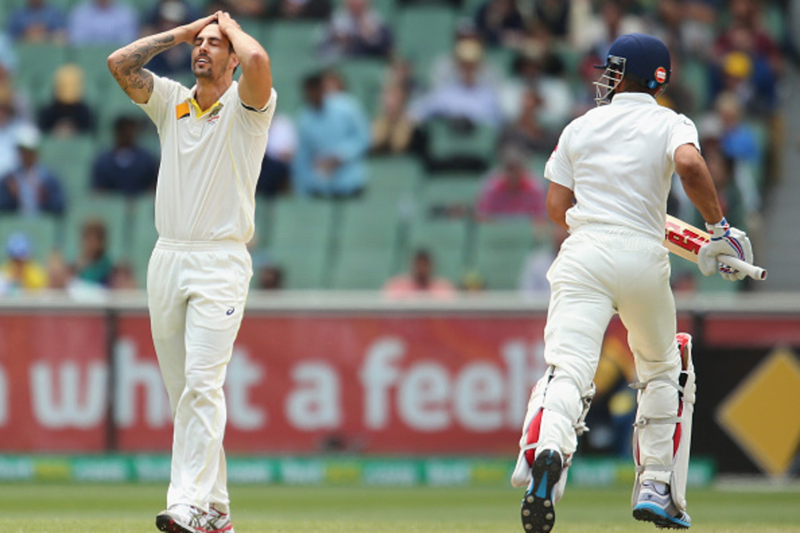 MELBOURNE, AUSTRALIA - DECEMBER 30:  Mitchell Johnson of Australia reacts after being hit for a boundary by Virat Kohli (R) of India during day five of the Third Test match between Australia and India at Melbourne Cricket Ground on December 30, 2014 in Me
