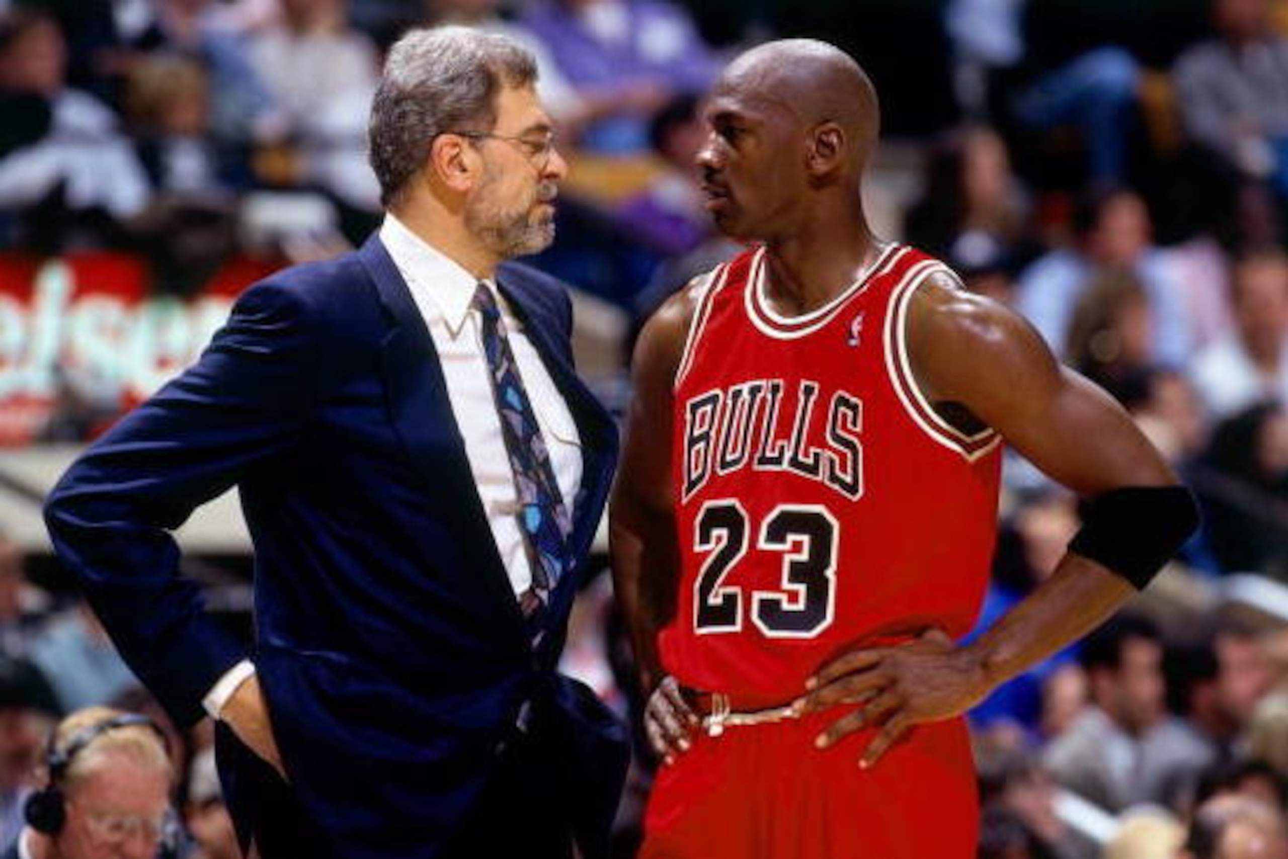 CHICAGO - JUNE 16:  Michael Jordan #23 of the Chicago Bulls discusses strategy with head coach Phil Jackson in Game Six of the 1996 NBA Finals against the Seattle SuperSonics at the United Center on June 16, 1996 in Chicago Iillinois.  The Bulls won 87-75