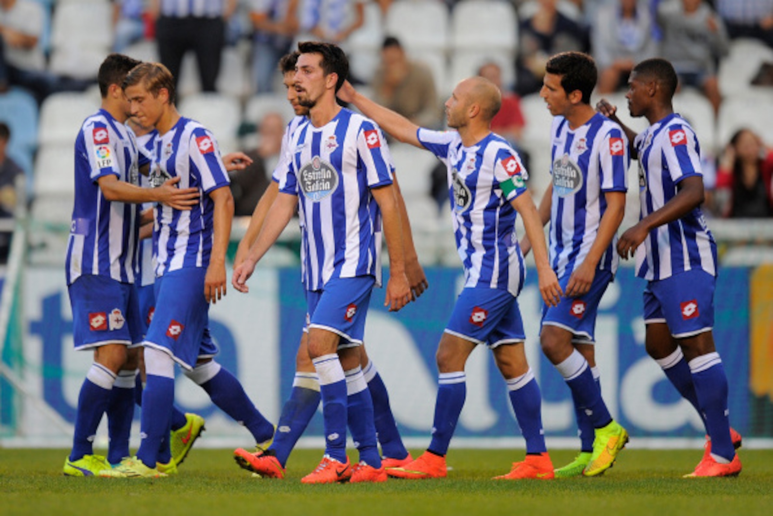 A CORUNA, SPAIN - AUGUST 10: Real Club Deportivo players celebrate after scoring a goal against Sporting de Gijon during the Teresa Herrera Trophy match at estadio Municipal de Riazor on August 10, 2014 in A Coruna, Spain. (Photo by Denis Doyle/Getty I A CORUNA, SPAIN - AUGUST 10: Real Club Deportivo players celebrate after scoring a goal against Sporting de Gijon during the Teresa Herrera Trophy match at estadio Municipal de Riazor on August 10, 2014 in A Coruna, Spain. (Photo by Denis Doyle/Getty I