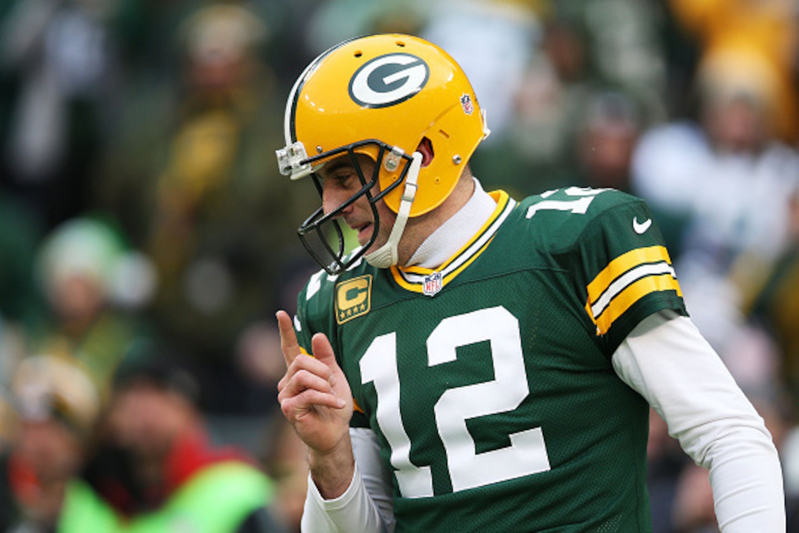 GREEN BAY, WI - DECEMBER 28:  Aaron Rodgers #12 of the Green Bay Packers reacts in the first quarter against the Detroit Lions at Lambeau Field on December 28, 2014 in Green Bay, Wisconsin.  (Photo by Chris Graythen/Getty Images)