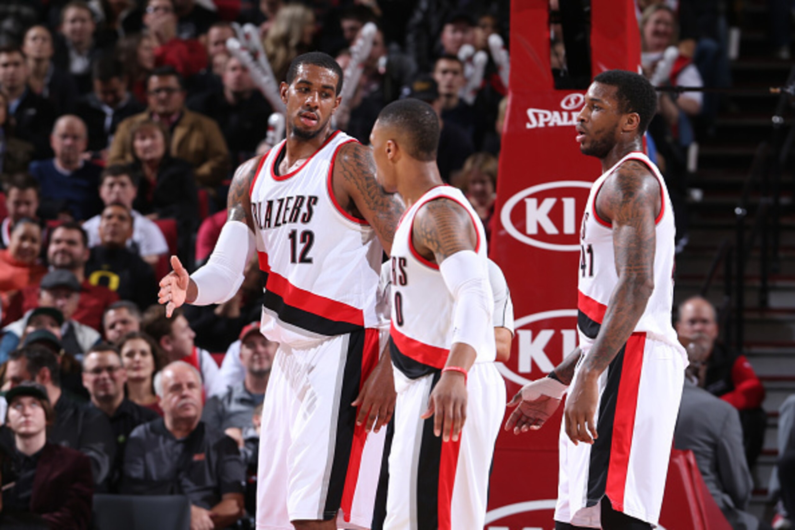 PORTLAND, OR - DECEMBER 15:  LaMarcus Aldridge #12, Thomas Robinson #41 and Damian Lillard #0 of the Portland Trail Blazers walk on the court against the San Antonio Spurs on December 15, 2014 at the Moda Center Arena in Portland, Oregon. NOTE TO USER: Us