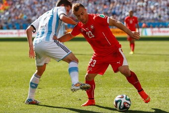 SAO PAULO, BRAZIL - JULY 01:  Fernando Gago of Argentina challenges Xherdan Shaqiri of Switzerland during the 2014 FIFA World Cup Brazil Round of 16 match between Argentina and Switzerland at Arena de Sao Paulo on July 1, 2014 in Sao Paulo, Brazil.  (Phot