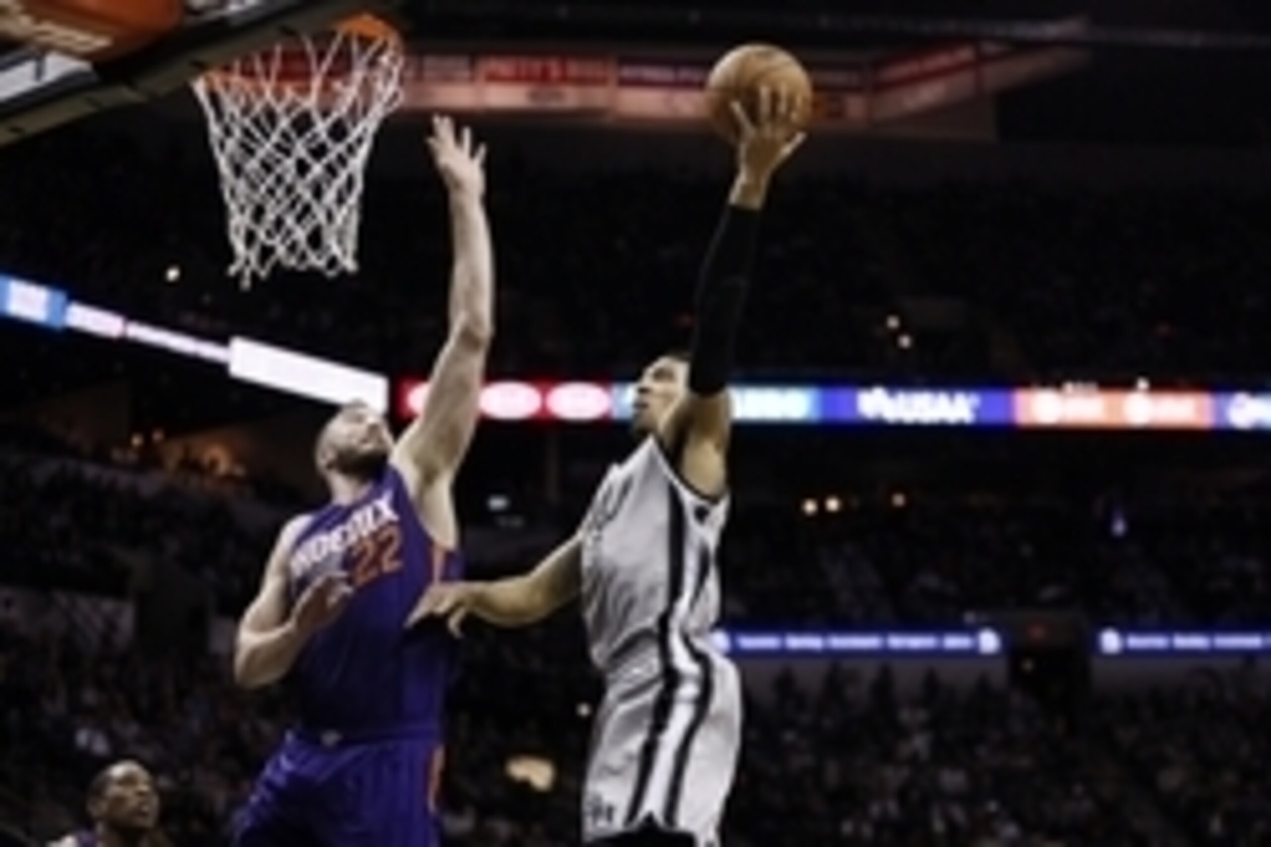 Jan 9, 2015; San Antonio, TX, USA; San Antonio Spurs shooting guard Danny Green (14) shoots the ball as Phoenix Suns center Miles Plumlee (22) defends during the second half at AT&T Center. Mandatory Credit: Soobum Im-USA TODAY Sports