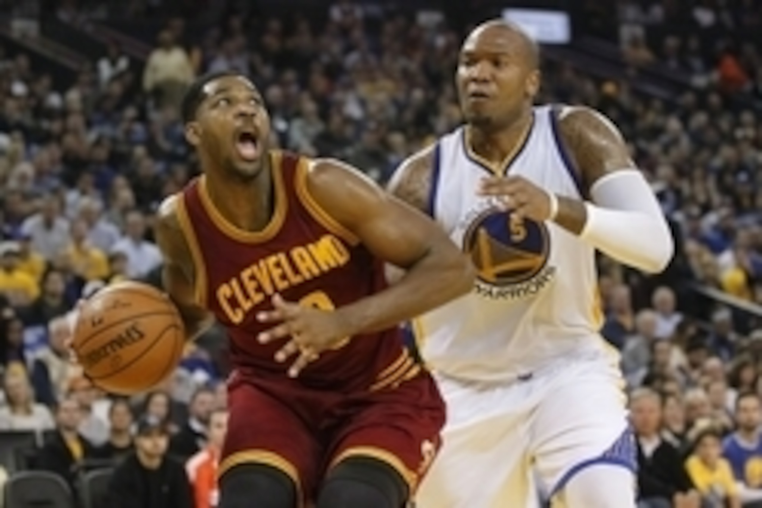 Jan 9, 2015; Oakland, CA, USA; Cleveland Cavaliers center Tristan Thompson (13) drives to the hoop next to Golden State Warriors center Marreese Speights (5) in the second quarter at Oracle Arena. Mandatory Credit: Cary Edmondson-USA TODAY Sports