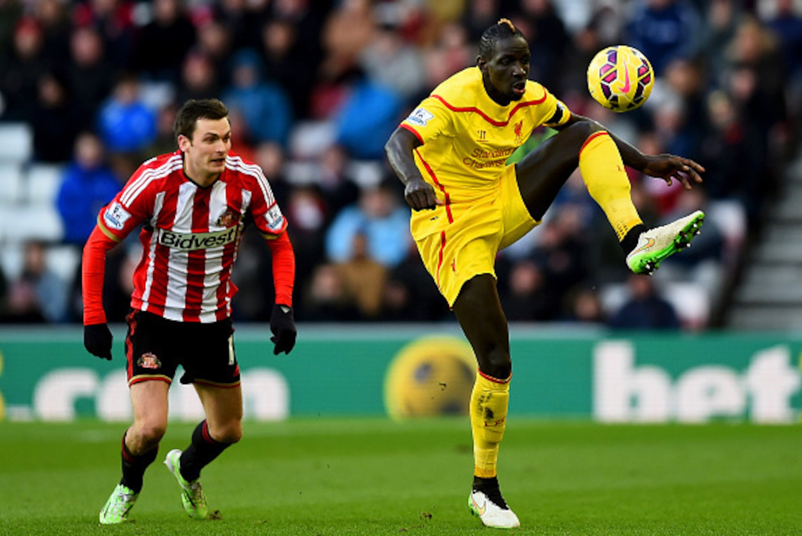 SUNDERLAND, ENGLAND - JANUARY 10:  Mamadou Sakho of Liverpool wears a black armband, in honour of the victims of the Charlie Hebdo attack in Paris, as he controls the ball next to Adam Johnson of Sunderland during the Barclays Premier League match between