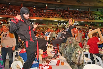 MELBOURNE, AUSTRALIA - JANUARY 10:  Spectators in fancy dress celebrate in the crowd during the Invitational Darts Challenge at Etihad Stadium on January 10, 2015 in Melbourne, Australia.  (Photo by Scott Barbour/Getty Images)