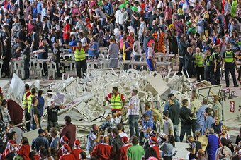 MELBOURNE, AUSTRALIA - JANUARY 10:  Security guards stand around a pile of plastic chairs and tables after spectators threw them during the final between Simon The Wizard Whitlock and Mighty Michael van Gerwen during the Invitational Darts Challenge at Et