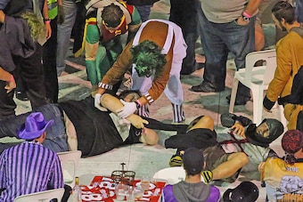 MELBOURNE, AUSTRALIA - JANUARY 10:  Spectators in fancy dress wrestle during the final between Simon The Wizard Whitlock and Mighty Michael van Gerwen during the Invitational Darts Challenge at Etihad Stadium on January 10, 2015 in Melbourne, Australia.  
