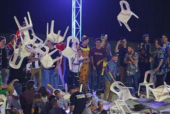 MELBOURNE, AUSTRALIA - JANUARY 10:  Spectators throw plastic chairs during the final between Simon The Wizard Whitlock and Mighty Michael van Gerwen during the Invitational Darts Challenge at Etihad Stadium on January 10, 2015 in Melbourne, Australia.  (P
