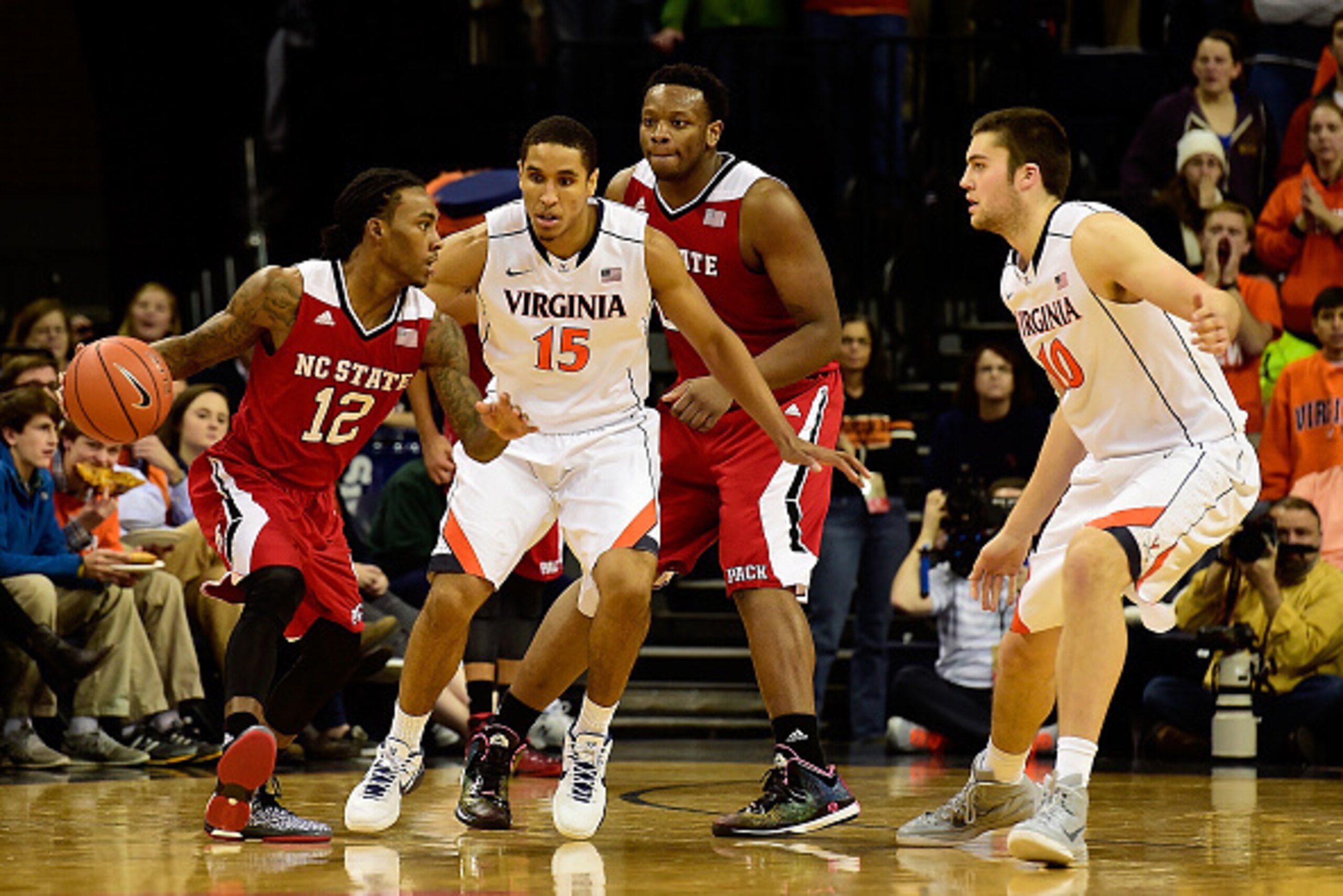 CHARLOTTESVILLE, VA - JANUARY 07:  Anthony Barber #12 of the North Carolina State Wolfpack handles the ball against Malcolm Brogdon #15 of the Virginia Cavaliers in the second half during a game at John Paul Jones Arena on January 7, 2015 in Charlottesvil
