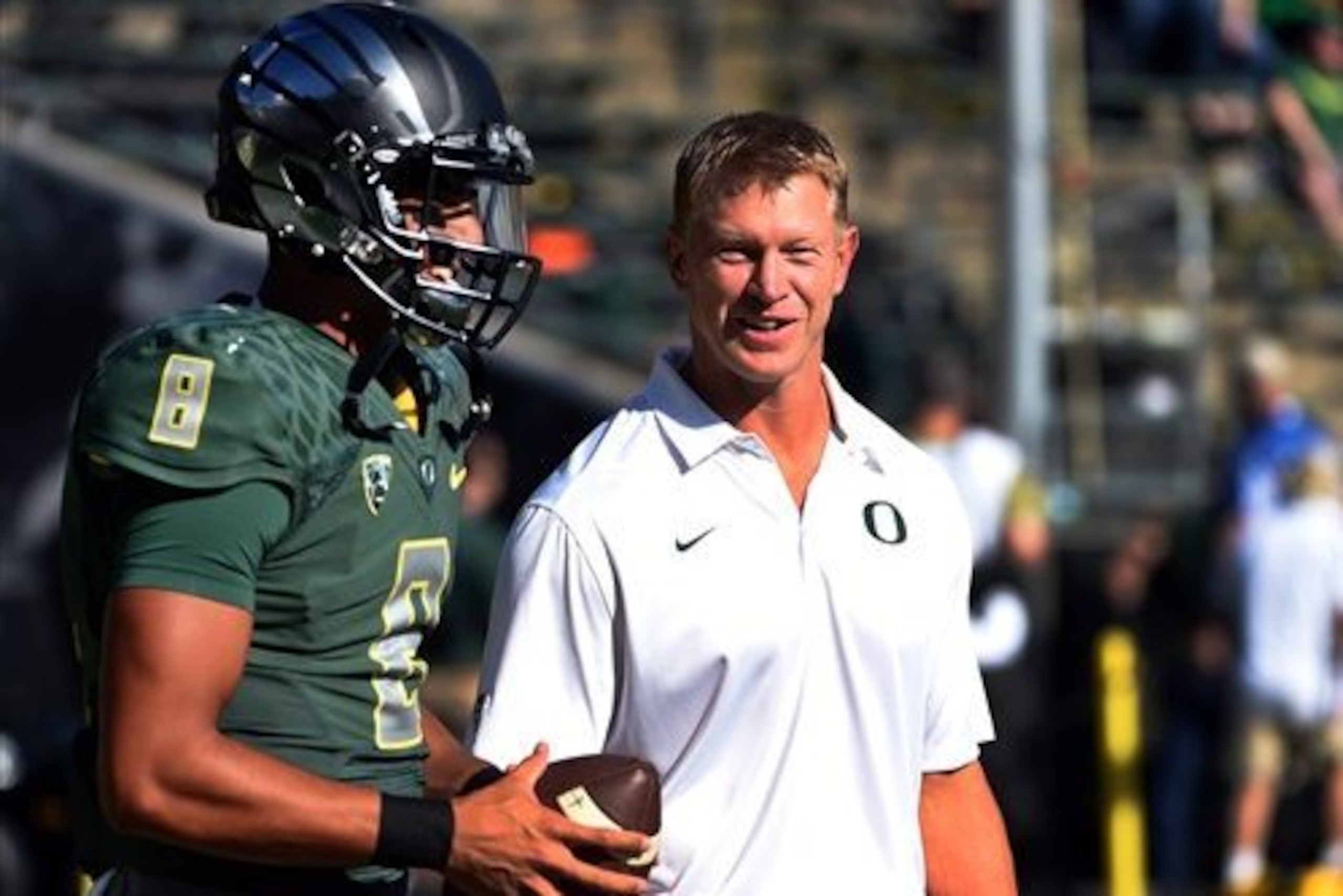 Oregon quarterback Marcus Mariota and offensive coordinator Scott Frost.
