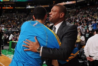 BOSTON, MA - JANUARY 16:  Austin Rivers #25 of the New Orleans Hornets hugs his dad Doc Rivers, head coach of the Boston Celtics on January 16, 2013 at the TD Garden in Boston, Massachusetts.  NOTE TO USER: User expressly acknowledges and agrees that, by 