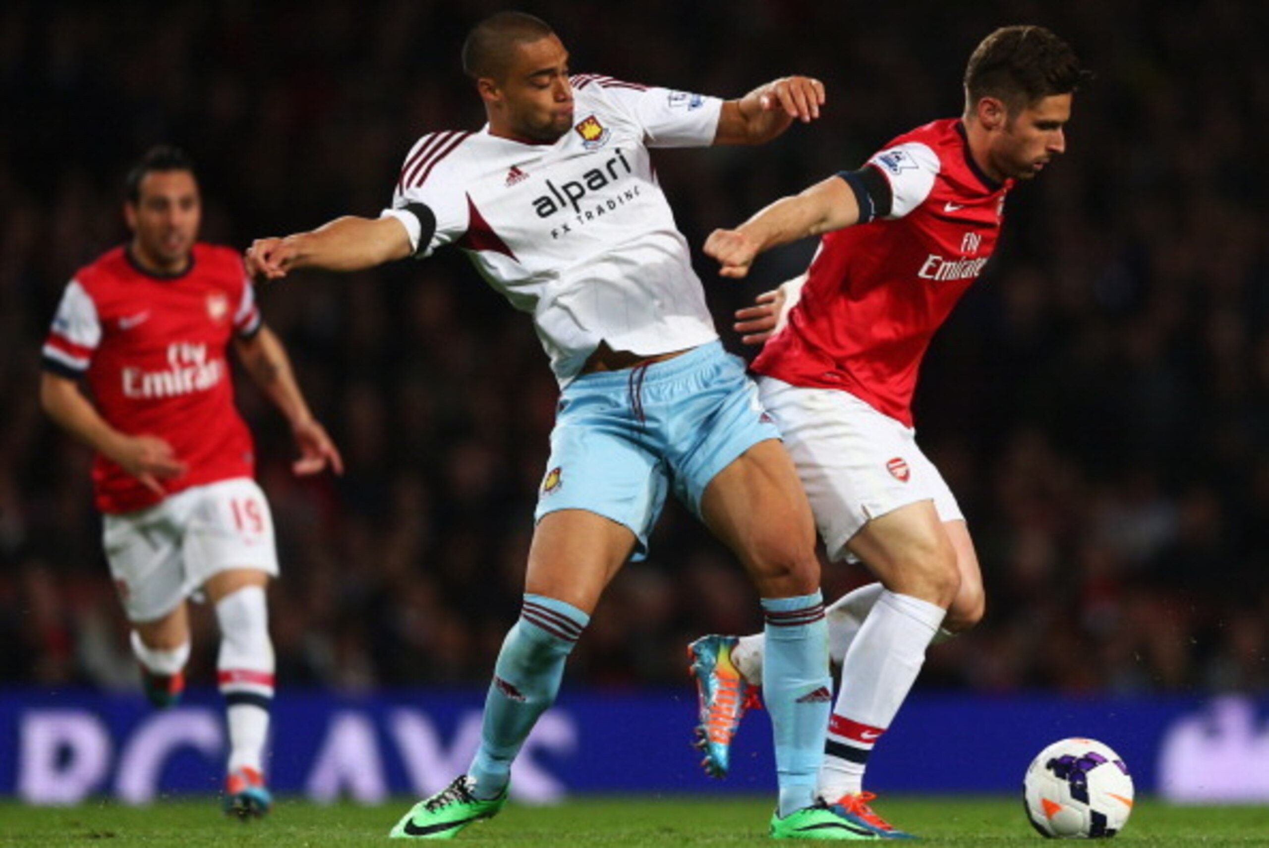 LONDON, ENGLAND - APRIL 15: Olivier Giroud of Arsenal holds off Winston Reid of West Ham United during the Barclays Premier League match between Arsenal and West Ham United at Emirates Stadium on April 15, 2014 in London, England. (Photo by Paul Gilham/ LONDON, ENGLAND - APRIL 15: Olivier Giroud of Arsenal holds off Winston Reid of West Ham United during the Barclays Premier League match between Arsenal and West Ham United at Emirates Stadium on April 15, 2014 in London, England. (Photo by Paul Gilham/