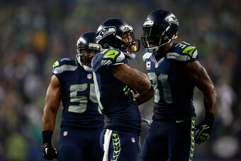 SEATTLE, WA - JANUARY 10:   Bruce Irvin #51 and Kam Chancellor #31 of the Seattle Seahawks celebrate a defensive play against the Carolina Panthers during the 2015 NFC Divisional Playoff game at CenturyLink Field on January 10, 2015 in Seattle, Washington